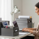 Woman working on a laptop at a desk with portable storage containers.