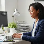Woman working at organized corner desk in home office.